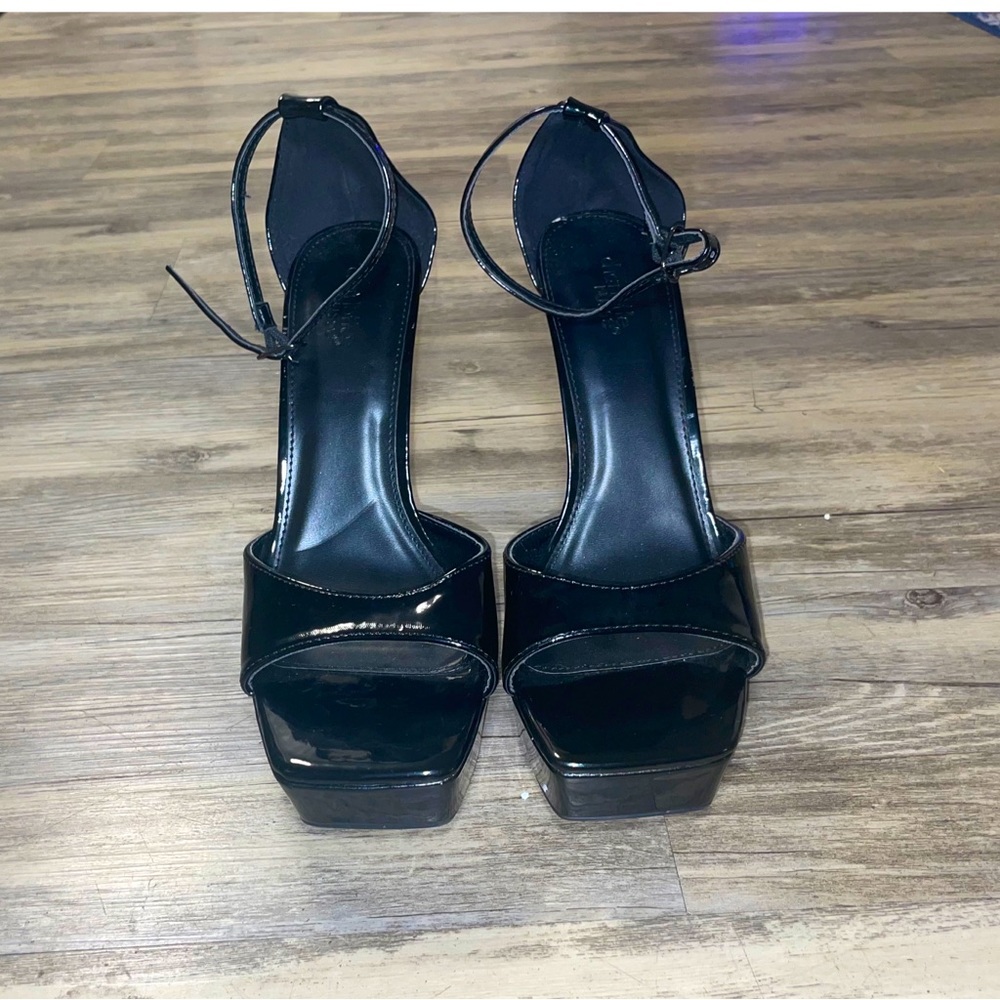 Black latex high heeled pumps